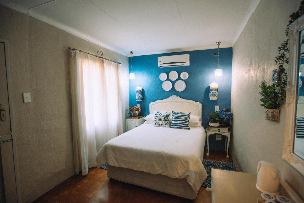 Room 3 double bed with blue feature wall